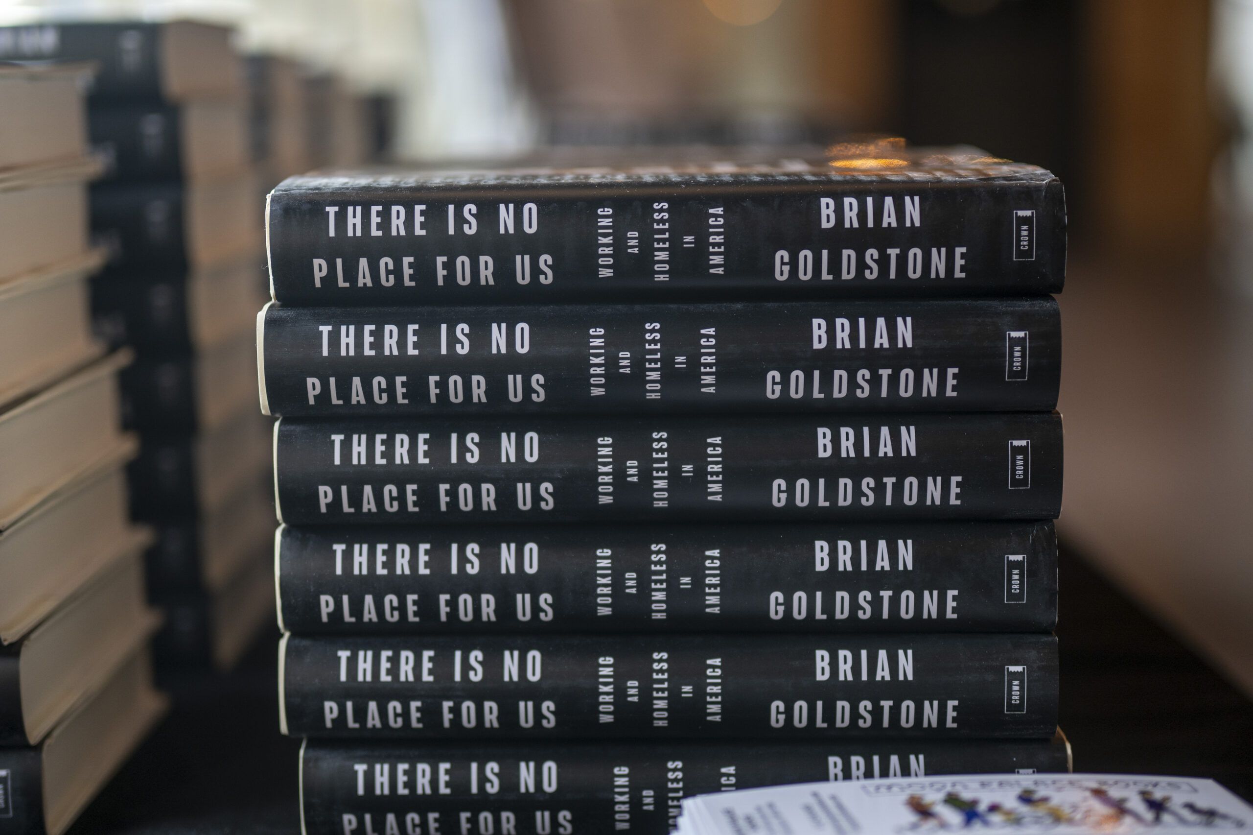 Aeon Affordable Homes A stack of books titled "There Is No Place For Us" by Brian Goldstone on a table.