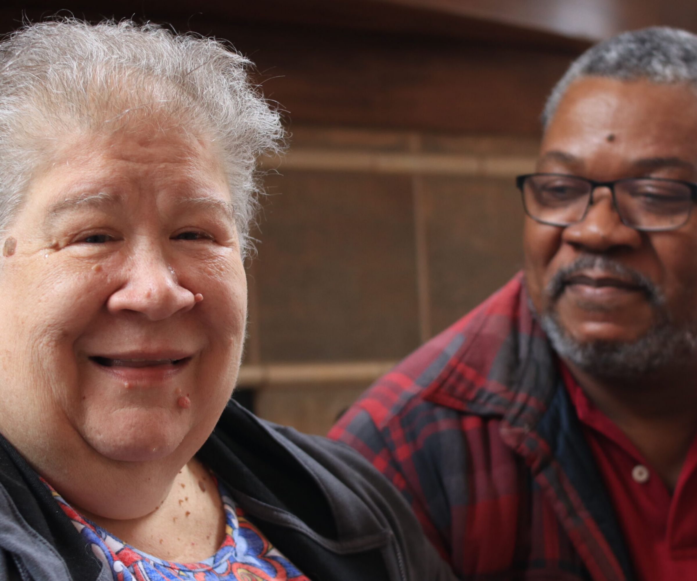 Aeon Affordable Homes Kim & Ernie share a warm moment indoors, their story told through smiles and affectionate glances.