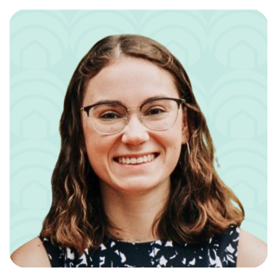 Aeon Affordable Homes Smiling woman with glasses and wavy brown hair, possibly Autumn Delong Rodgers, wears a patterned top against a teal patterned background.