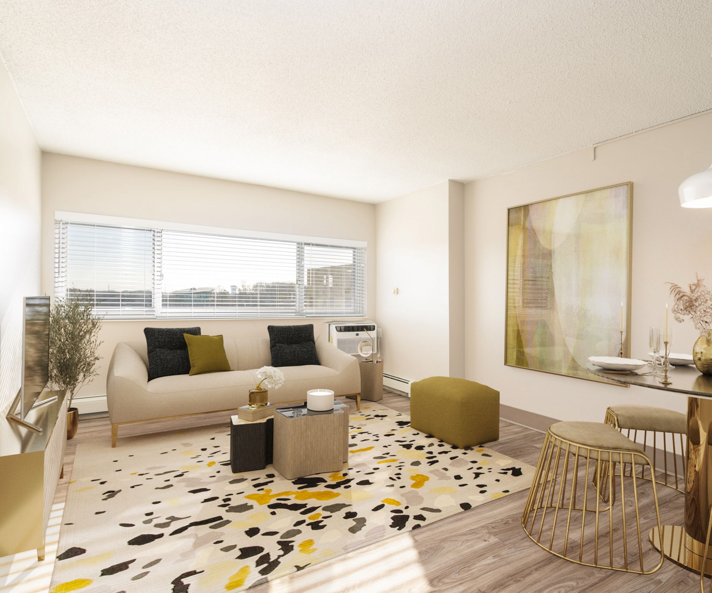 Aeon Affordable Homes and Community Bright living room with a beige sofa, modern decor, and abstract art in affordable apartment homes. Dining area features golden chairs by a large window.