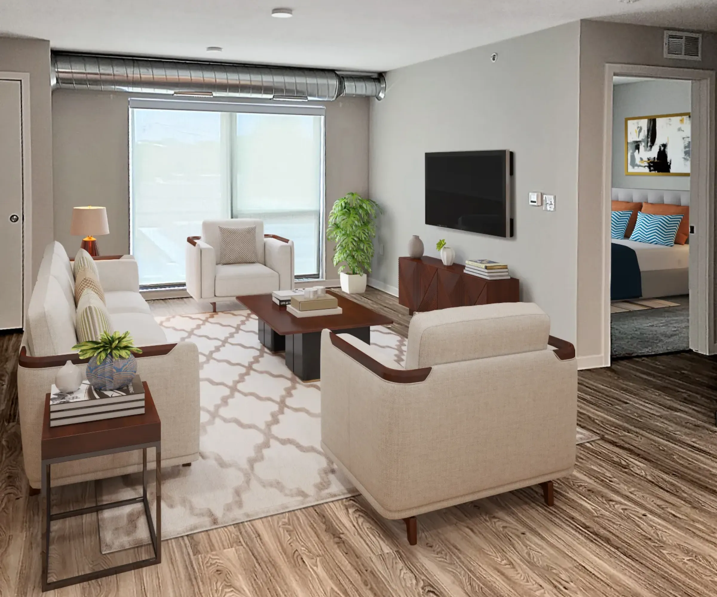 Aeon Affordable Homes and Community Modern living room in affordable apartment homes with beige sofas, wooden table, TV, and large window. Bedroom visible through an open door.