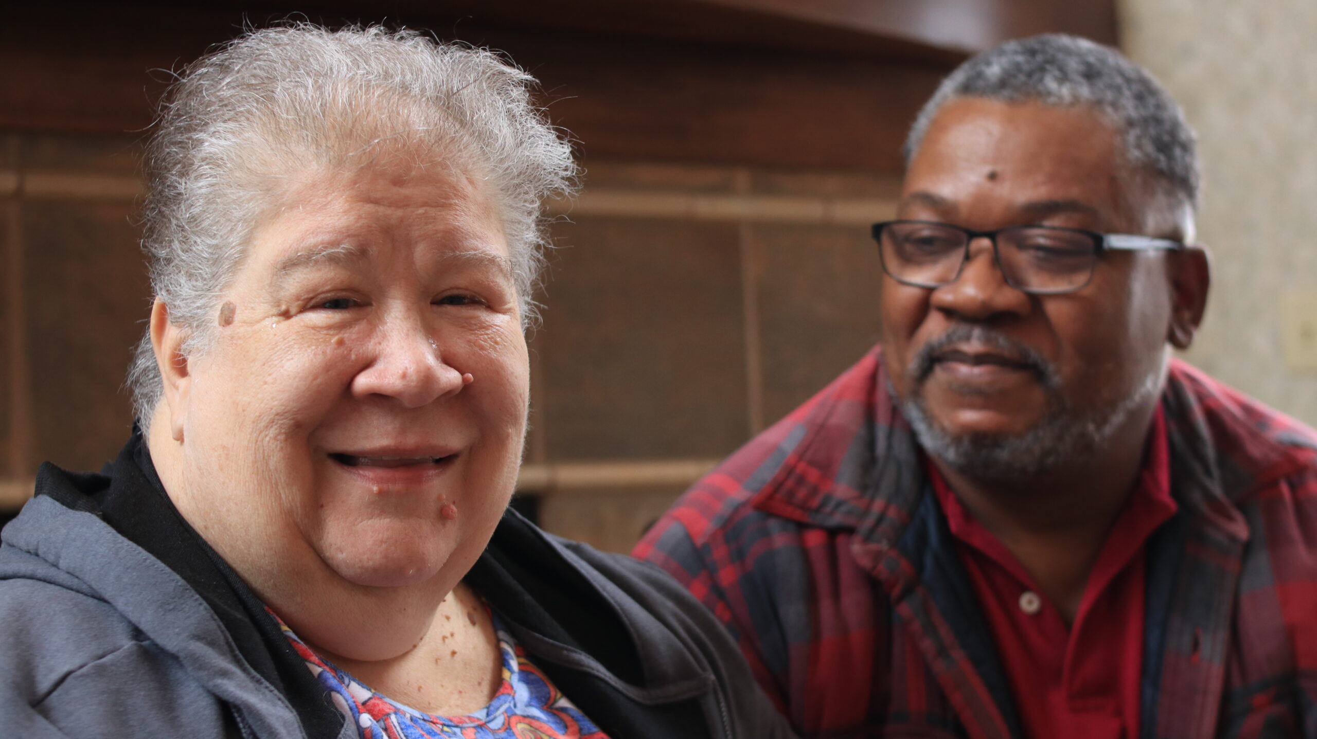 Aeon Affordable Homes Kim & Ernie share a warm moment indoors, their story told through smiles and affectionate glances.