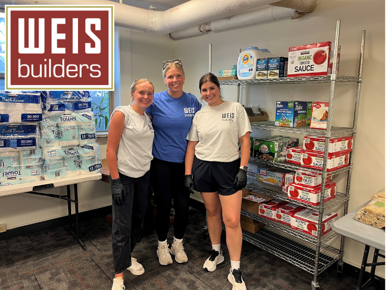 Aeon Affordable Homes Three women in WEIS shirts stand in a food pantry, showing how Caring Partners help build Stronger Communities; WEIS Builders logo in corner.